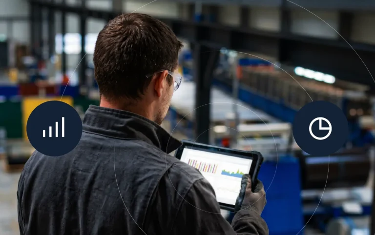 manažér výroby pozerá na tablet, kde má zobrazené grafy z ERP